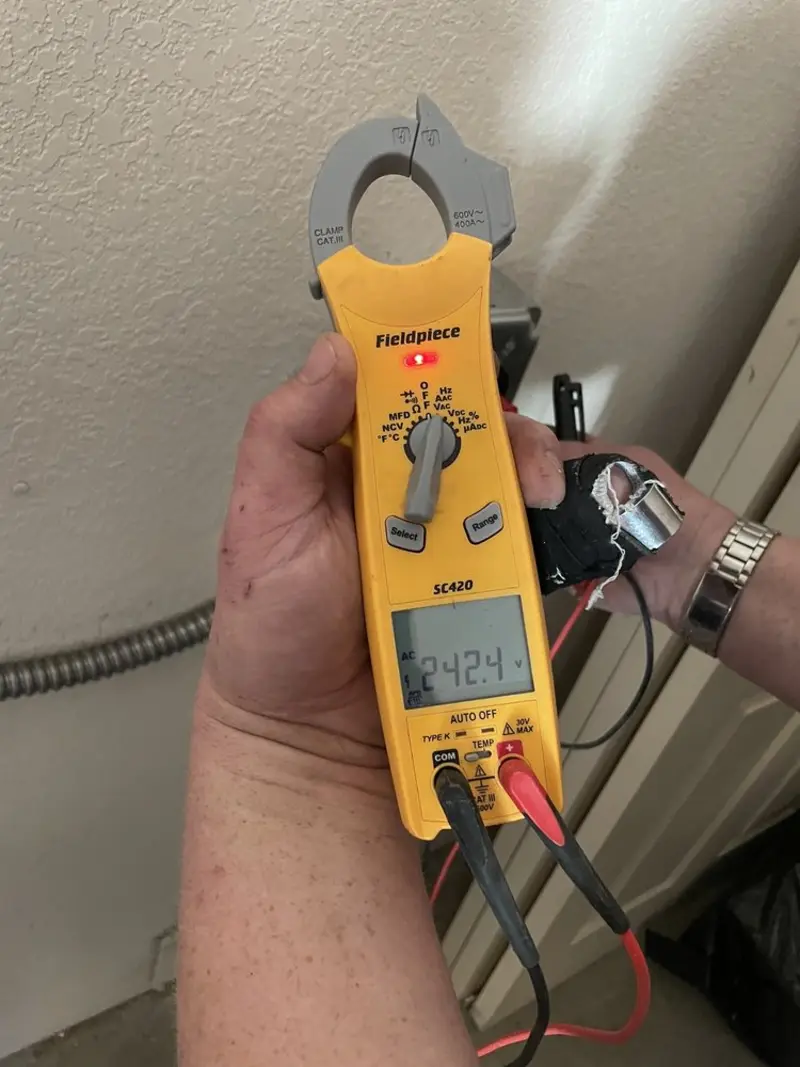 Voltage testing with clamp meter during Recessed Lighting Installation in Kingwood